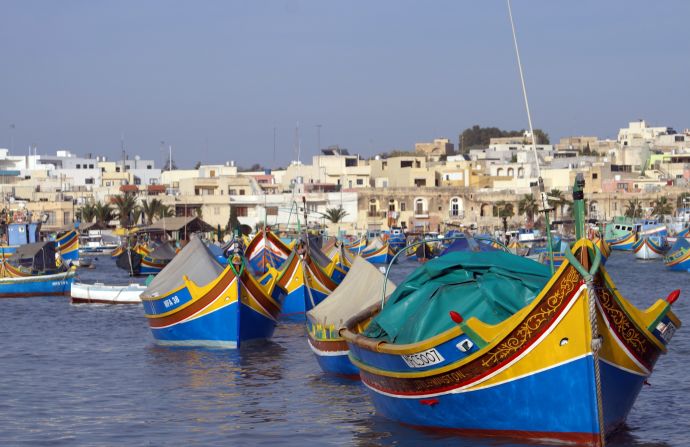 Marsaxlokk, a town whose name means "port in the southeast," is home to traditional fishing boats known as luzzu. Many still bear the Eye of Osiris, a tradition handed down by the Phoenicians to ward off evil.