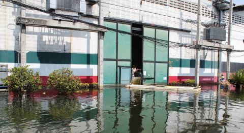 Like many businesses across Thailand, Romeo's factory is fighting to keep out the surrounding water.