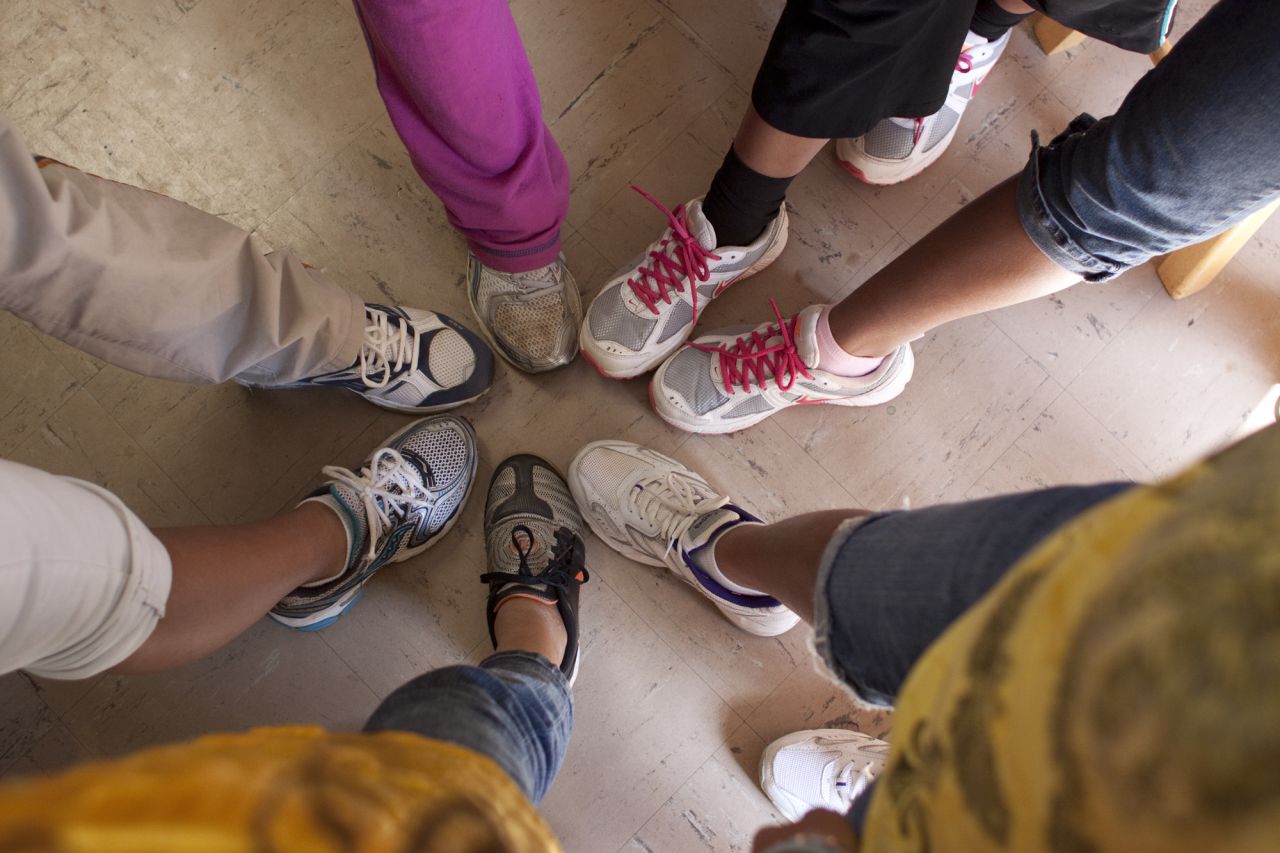 The students show off their sneakers, donated by volunteer Bobby King. The school survives solely on grants and donations.
