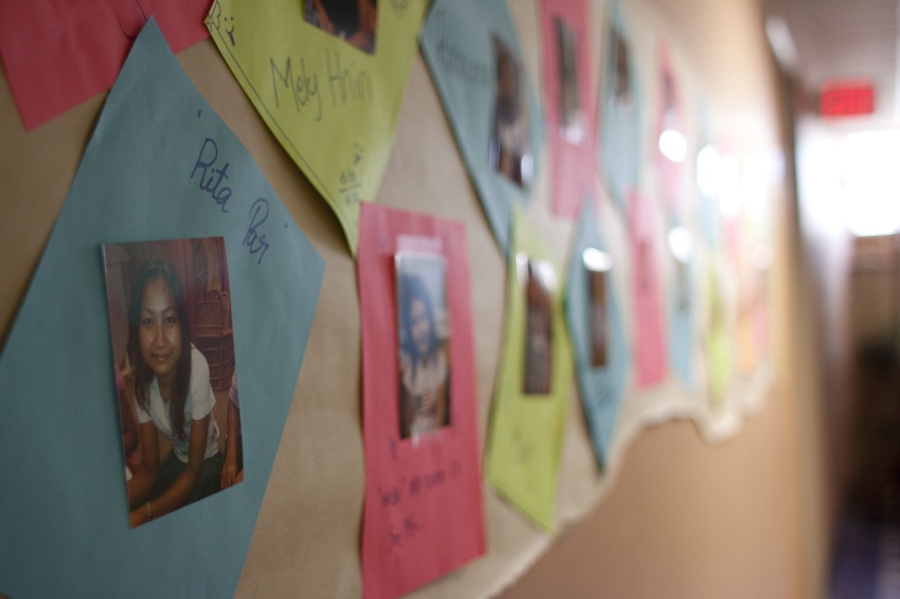 Photos of the students line the hallway of Global Village.