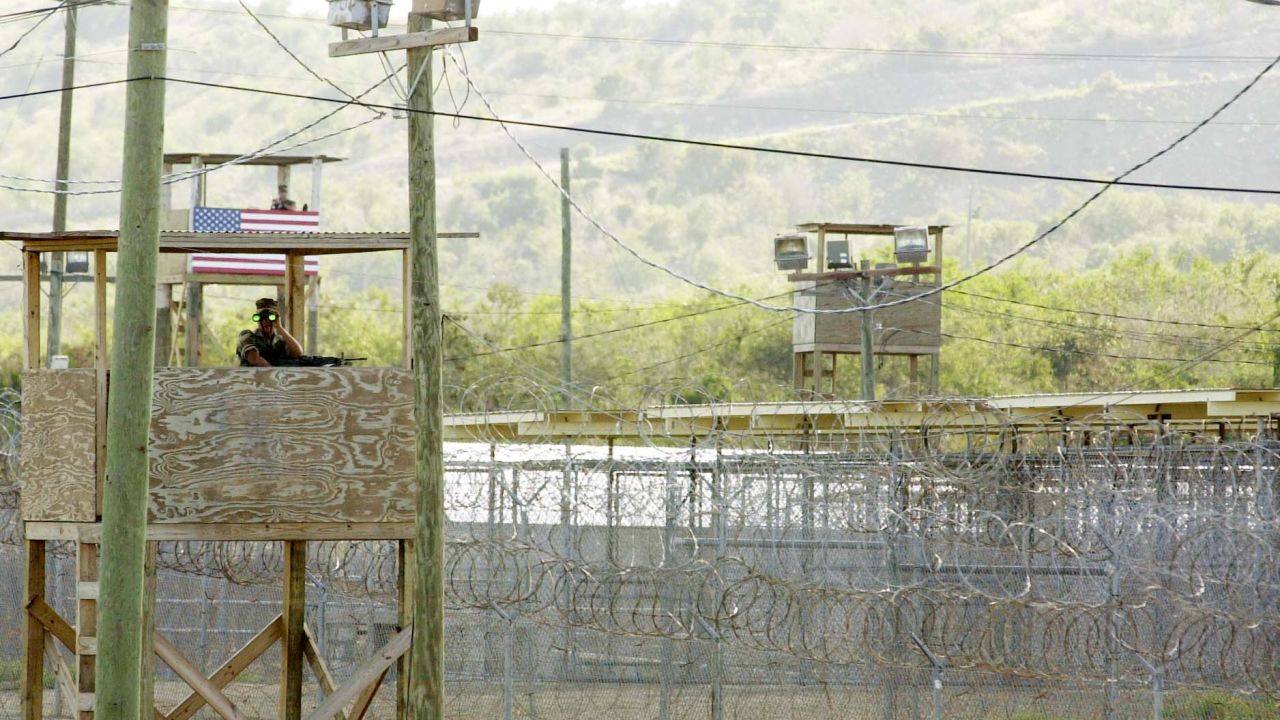 A U.S. Marine mans  an observation tower outside Camp X-Ray in Guantanamo Bay, Cuba, in a 2002 photo.