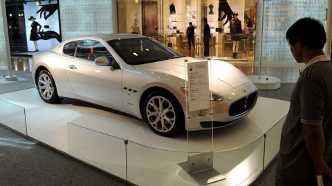 A man looks at a Maserati sports car on display at a luxury mall in Shanghai in September, 2011. 