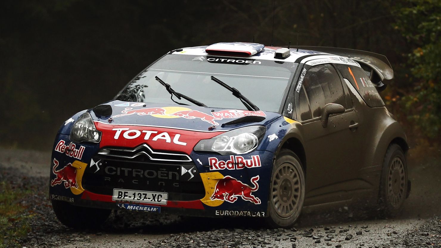 Sebastien Loeb powers his Citroen through as he leads the Wales Rally GB and clinches world title.