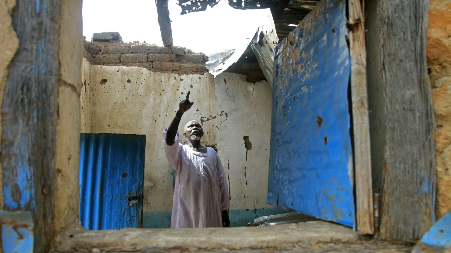 A Sudanese man surveys damages last month at his house caused by fighting in the border region of South Kordofan.