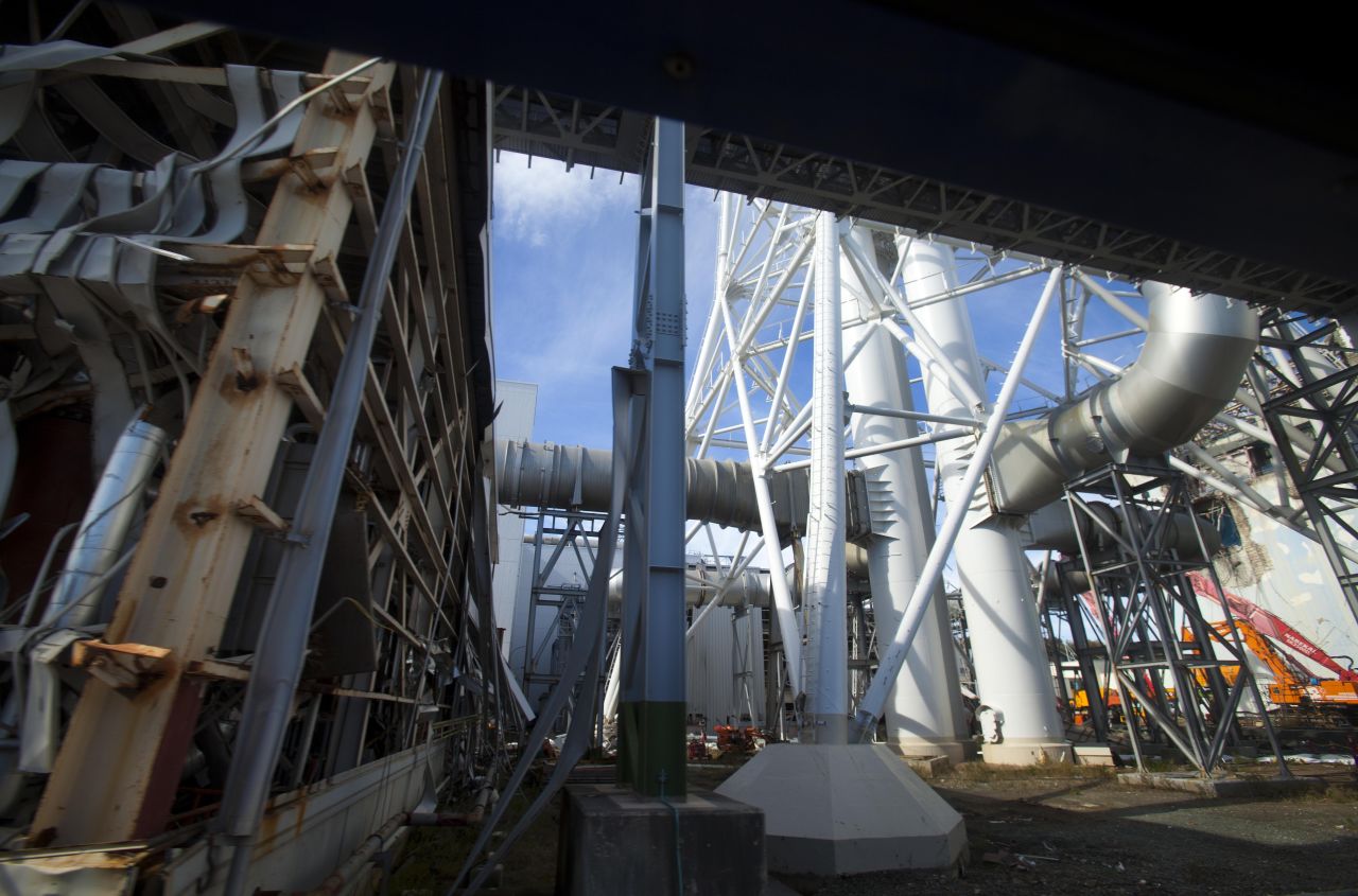 Radiation readings rose steadily as the journalists neared the plant, reaching 6.7 microsieverts in Okuma. There, they put on respirator masks, adding to an ensemble of a protective suit, two pairs of gloves, two sets of plastic booties over their shoes and a radiation detector.