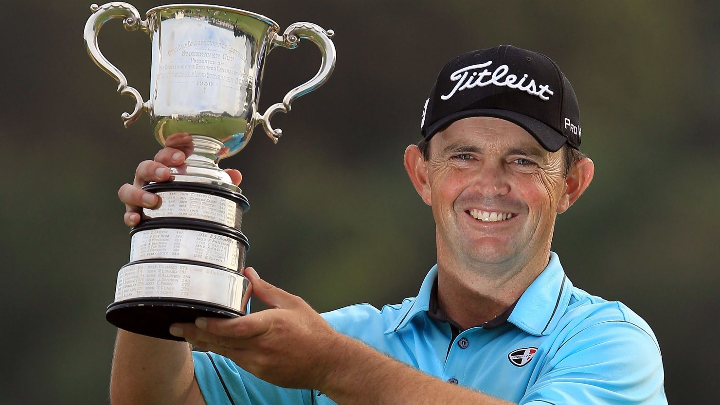 Greg Chalmers holds the Australian Open trophy aloft, 13 years after his last victory.