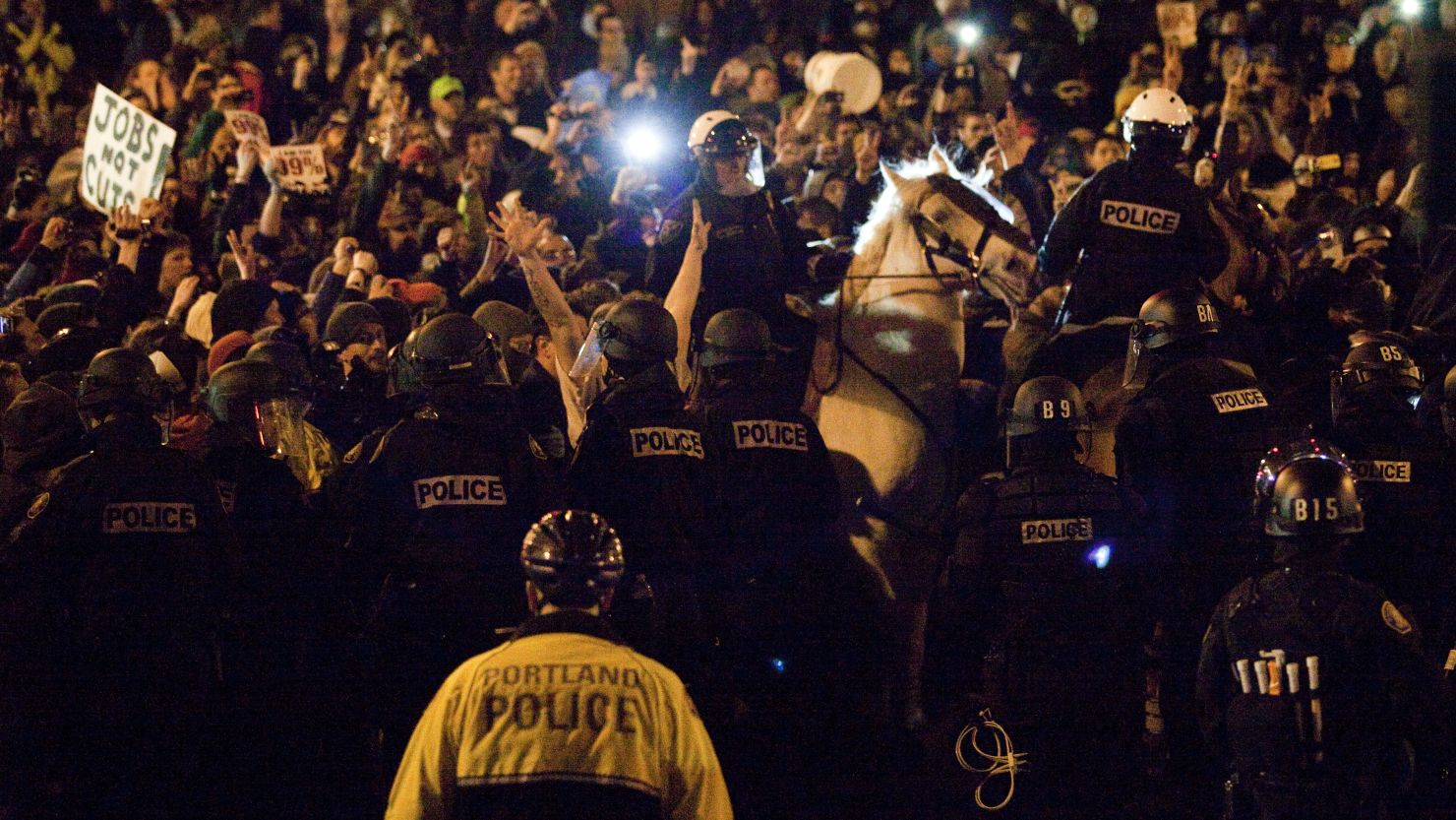 Police attempt to disperse a crowd at Occupy Portland on Sunday.