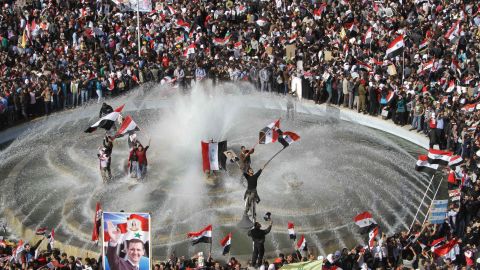 Syrians show their support for President Bashar al-Assad in Damascus on November 13.