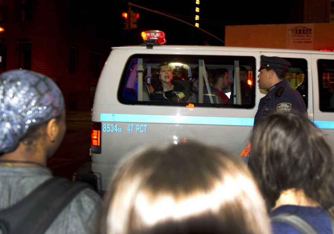 An arrested protester screams from a police van Tuesday.