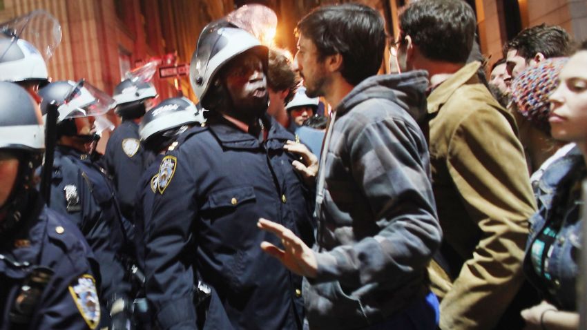 NEW YORK, NY - NOVEMBER 15: Occupy Wall Street protesters face off with police after the police in riot gear removed the protesters early in the morning from Zuccotti Park on November 15, 2011. Hundreds of protesters, who rallied against inequality in America, have slept in tents and under tarps since Sept. 17 in Zuccotti Park and has since become the epicenter of the global Occupy movement. The raid in New York City follows recent similar moves in Oakland, California, and Portland, Oregon. (Photo by Spencer Platt/Getty Images) 