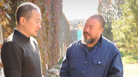Chinese artist Ai Weiwei (R) talks to an unidentified friend in the his courtyard home and studio on November 9. 