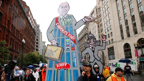 Activists carry a placard depicting Congress as a puppet of corporate lobbyists in a May, 2010 event in Washington.