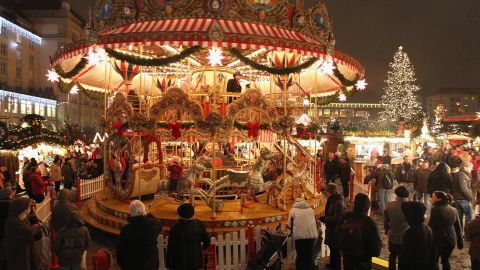 Visitors watch an ornate merry-go-round at the illuminated Dresdner Striezelmarkt Christmas market on November 26, 2010 in Dresden, Germany. The Striezelmarkt claims to be Germany's oldest Christmas market and dates back to 1434. Christmas markets have a long tradition in Germany and usually sell gluhwein, Christmas decorations and ornaments, sweets and sausages.