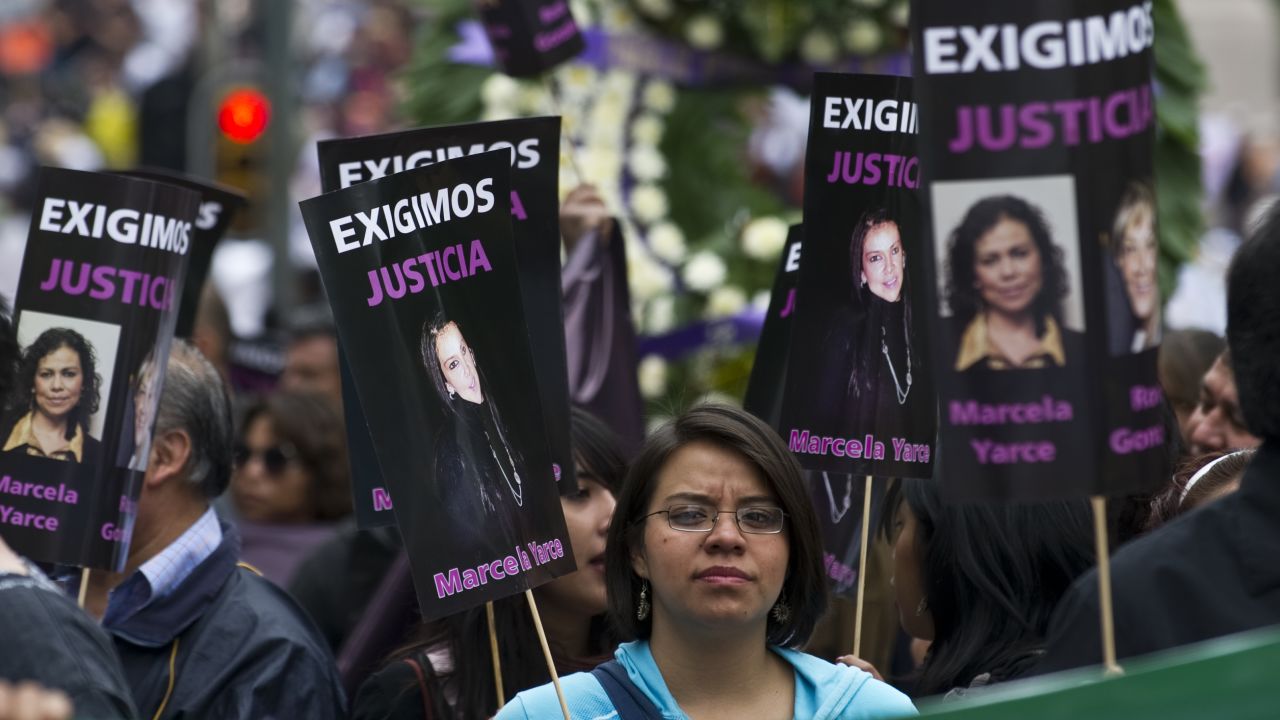 People hold signs during a protest against violence towards journalists in Mexico, on September 11, in Mexico City. 
