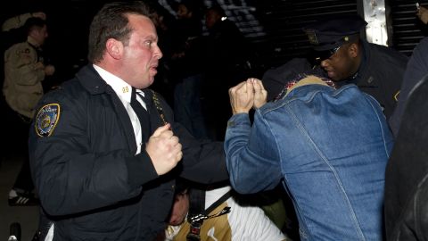 A New York police officer scuffles with Occupy Wall Street protesters in November 2011.