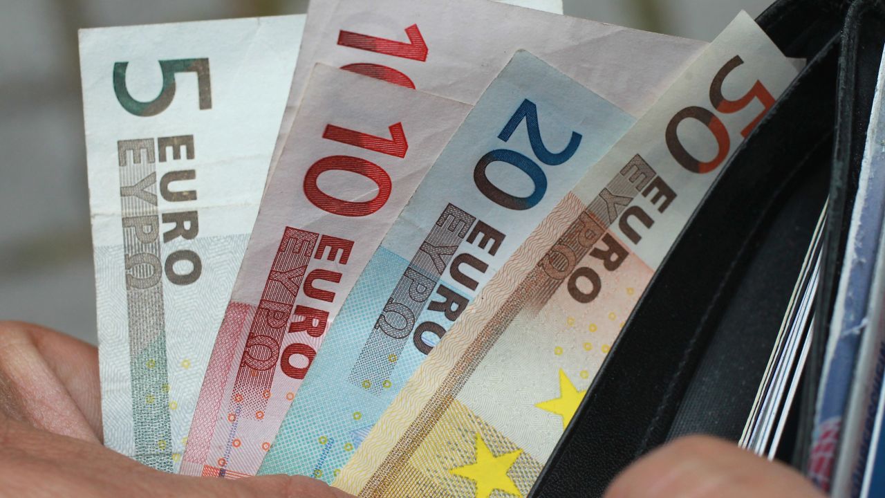 In this photo illustration a man removes Euro currency bills from a wallet on June 21, 2011 in Berlin, Germany.