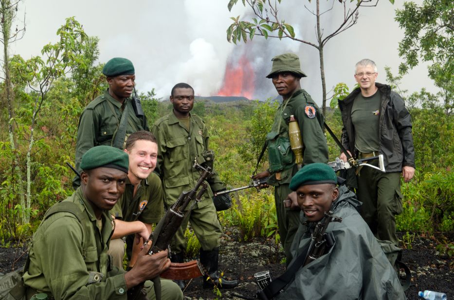 Some of the Virunga National Park team pose in front of the erupting volcano during a trek to the eruption site soon after it started on November 6.