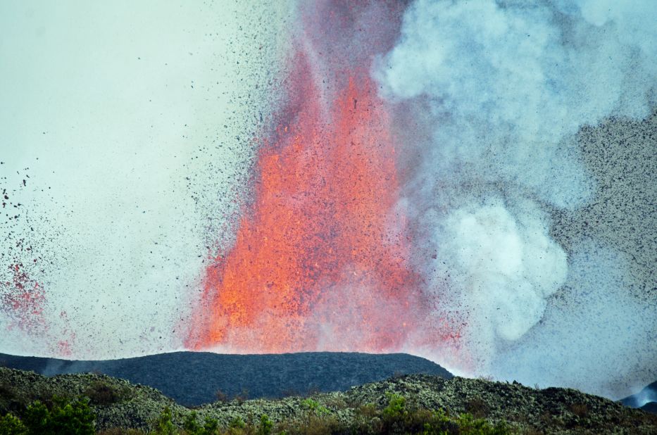 A close up shot of Mount Nyamulagira seemingly spewing small, weightless lava pebbles.