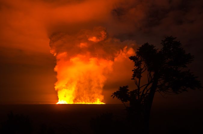 A skyline photograph taken from a high vantage point shows the immense power of the Nyamulagira volcano.