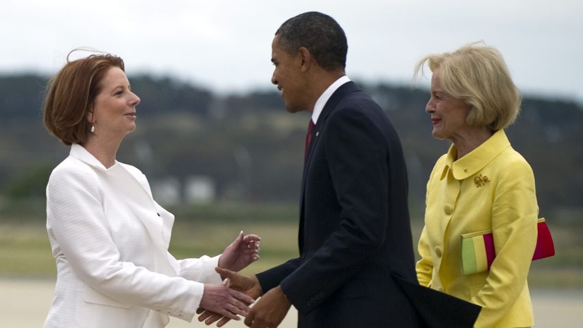 President Barack Obama is greeted by Australian Prime Minister Julia Gillard, left, and Governor General Quentin Bryce.