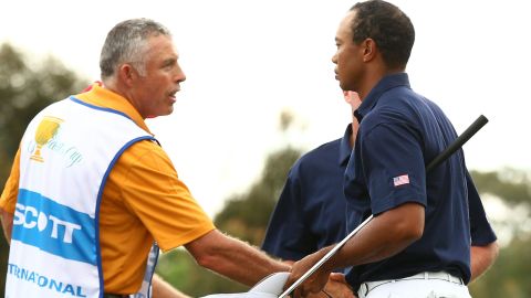 Tiger Woods and Steve Williams shake hands after the International pairing's comprehensive win in game six.