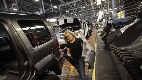 Pam Bialecki installs carpet into a Jeep Liberty at the Toledo Assembly Complex this week in Toledo, Ohio. Chrysler Group LLC says it will add 1,100 jobs at the assembly complex. 