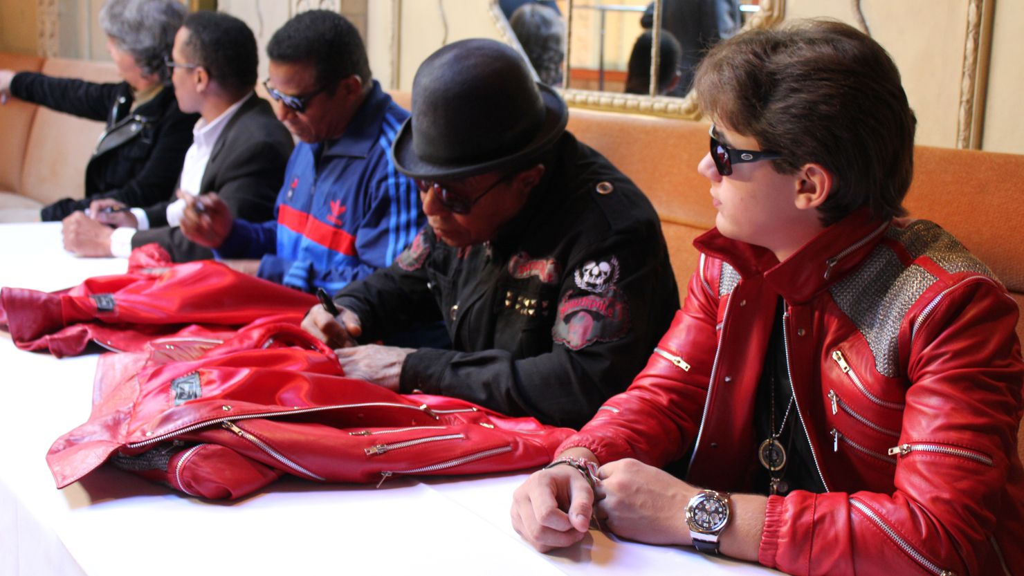 Prince Jackson with uncles Jackie, Marlon, and Tito Jackson,  seen here signing special edition "Beat It" jackets last month.