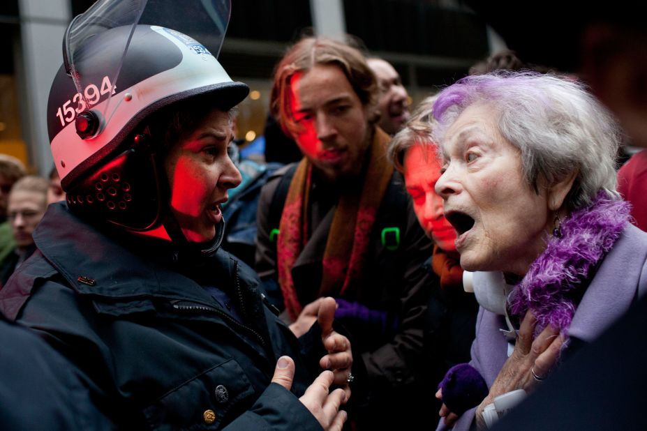 A woman talks with police as demonstrators block roads and tie up traffic in Lower Manhattan.