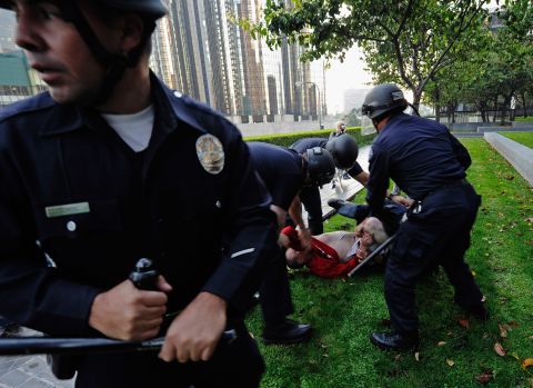 Police tackle a protester near the park where Occupy demonstrations were taking place in Los Angeles on Thursday.