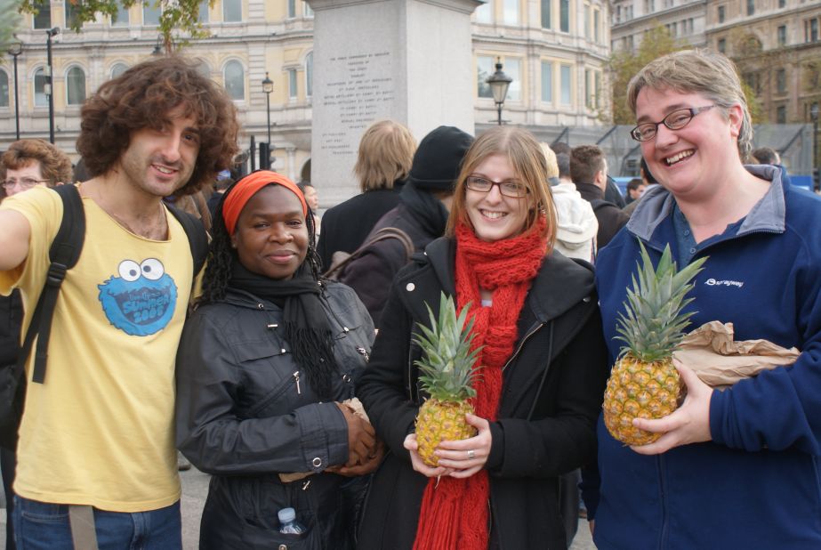 Volunteers from a Jewish charity show off waste pineapples which are being given to the public. Shelley Shocolinksky-Dwyer (far right) says: "We wanted to help raise awareness and spread the message about food waste in the United Kingdom."