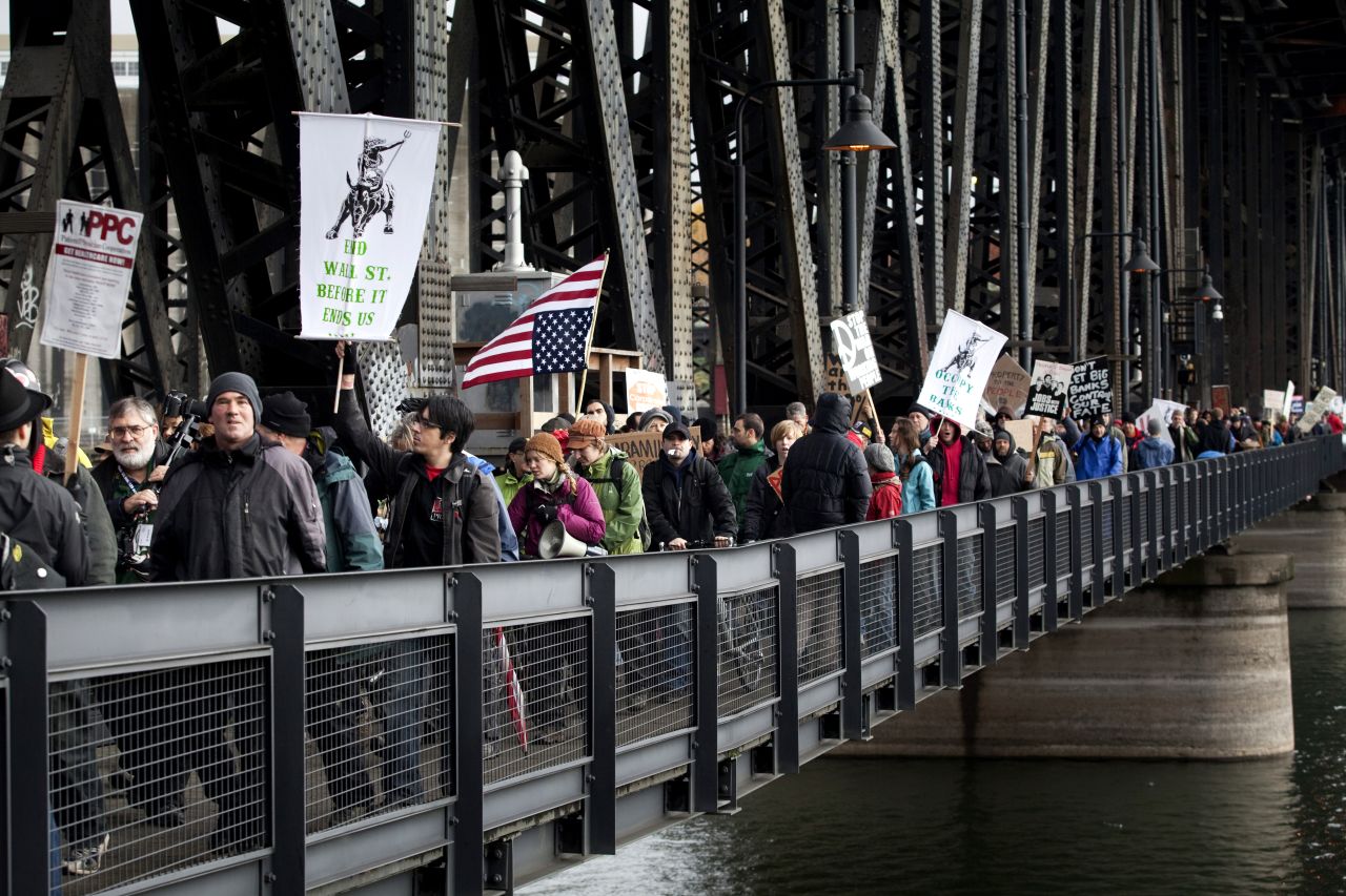 Demonstrators march across the Steel Bridge in Portland on Thursday.