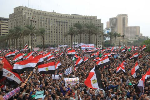 Tens of thousands of Egyptians wave national flags during a rally to protest against military rule in Cairo's Tahrir Square last November.