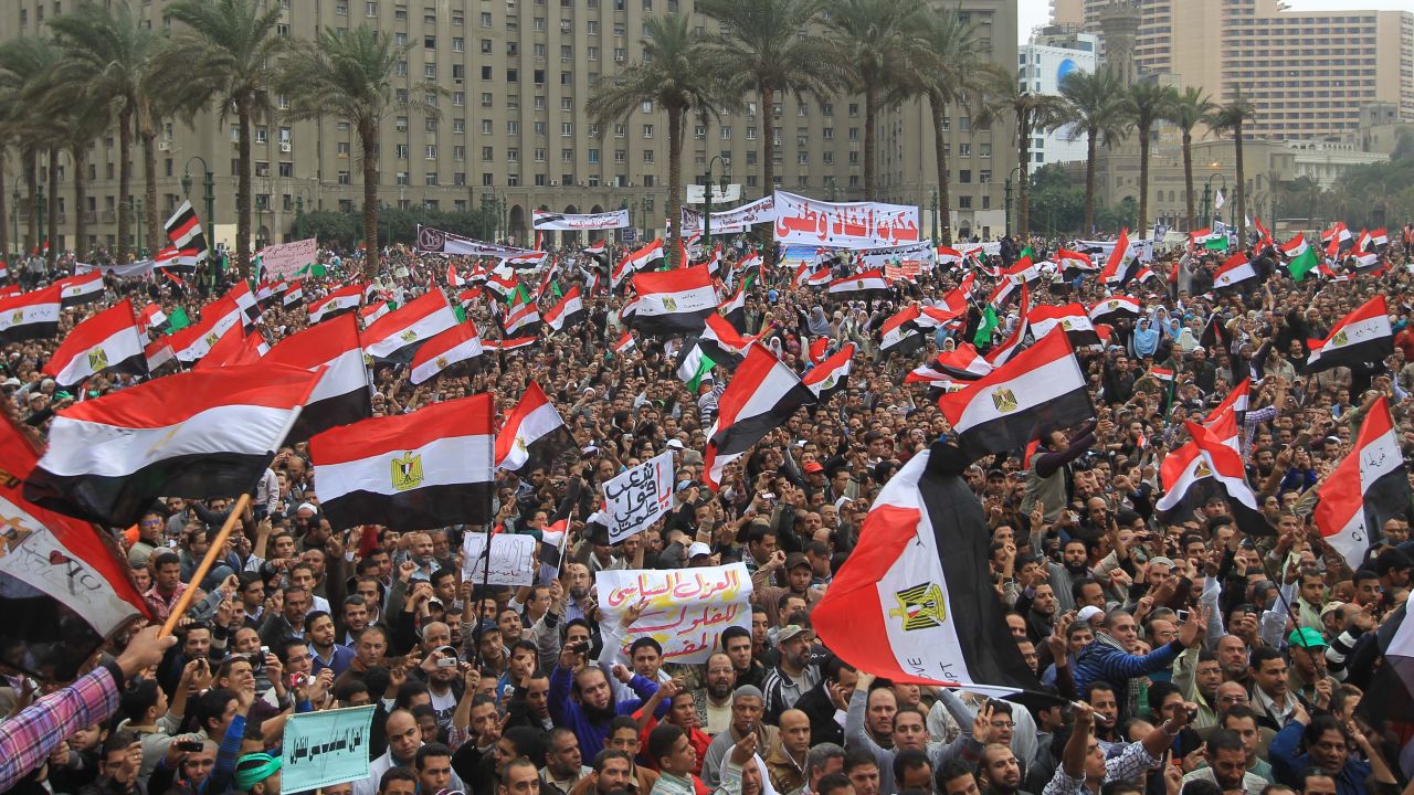 Tens of thousands of Egyptian protesters wave national flags during a rally in Tahrir Square on November 18, 2011.