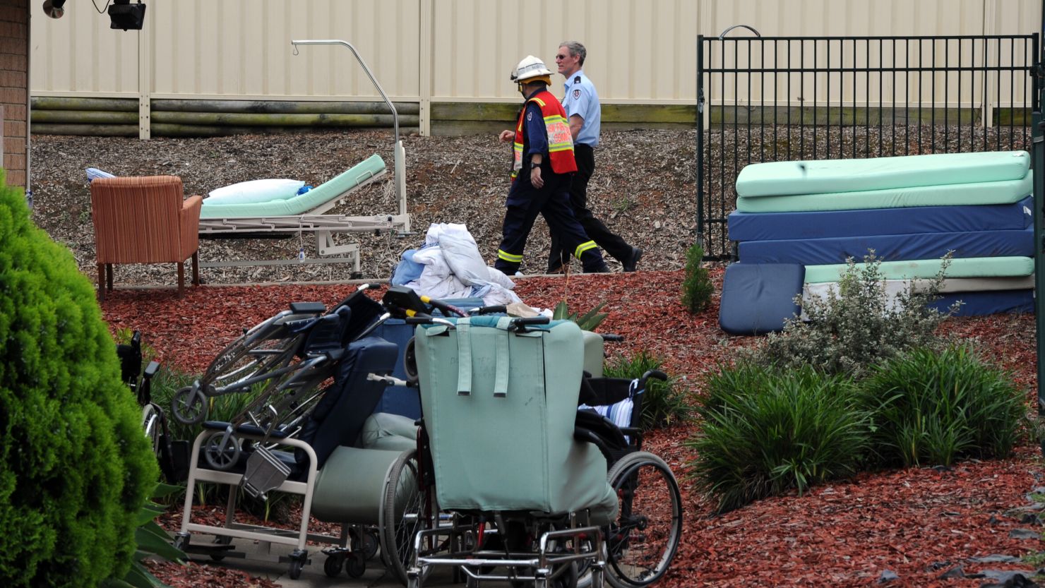 Firemen pass abandoned wheel chairs and hospital beds after a fire engulfed a nursing homes for the elderly, killing at least three and seriously injuring eight, near Sydney on November 18.