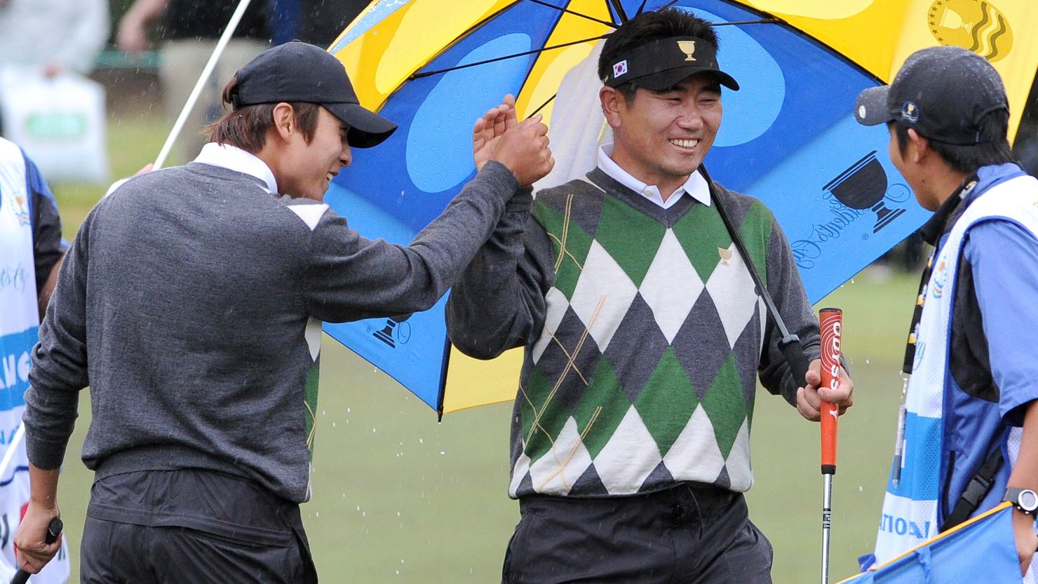 International team players K.T. Kim, left, and Y.E. Yang celebrate after beating Dustin Johnson and Tiger Woods on Saturday.