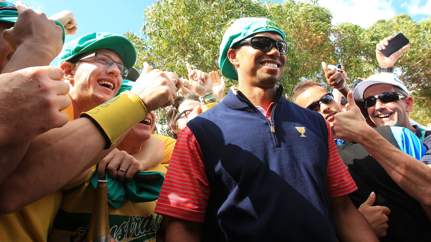 Tiger Woods is congratulated by fans after his winning putt ensured the United States retained the Presidents Cup.