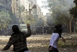 Egyptian protesters throw stones at riot police during clashes at Cairo's Tahrir Square in November 2011.