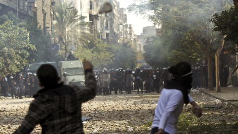 Egyptian protesters throw stones at riot police in Cairo's Tahrir Square on Sunday. 
