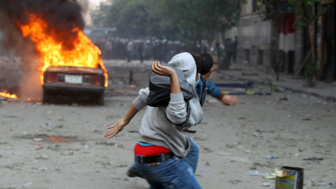 Egyptian protesters throw stones during clashes with security forces on Monday in Cairo's Tahrir Square.