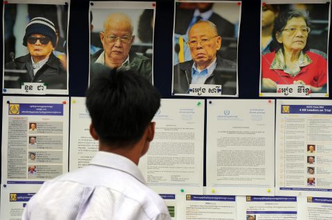 A Cambodian man looks at pictures of former Khmer Rouge leaders in 2011 on trial for their role during the bloody four-year regime.