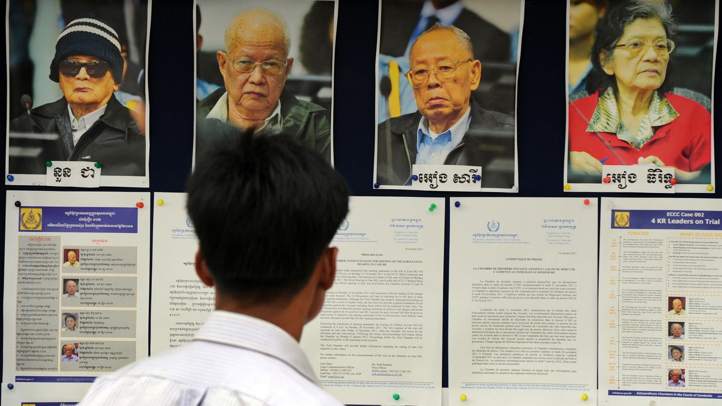 A Cambodian man looks at pictures of former Khmer Rouge leaders, three of whom are on trial.
