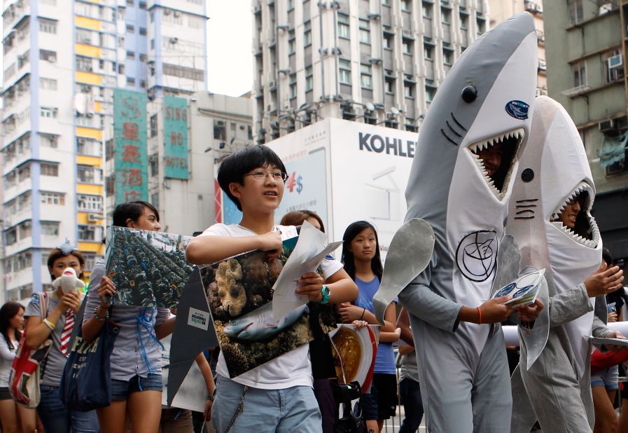 Supporters of the Hong Kong Shark Foundation march along a street to raise awareness for sharks killed each year for their fins, in Hong Kong on September 25.