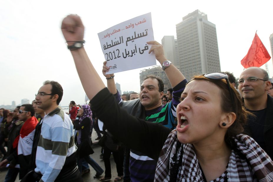 Protesters shout and carry signs through Tahrir Square on Friday, November 18, during a demonstration calling on the Egyptian military to end its rule.