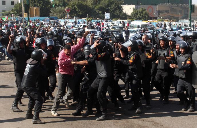 A protester struggles against riot police Saturday in Tahrir Square after police dispersed a demonstration.