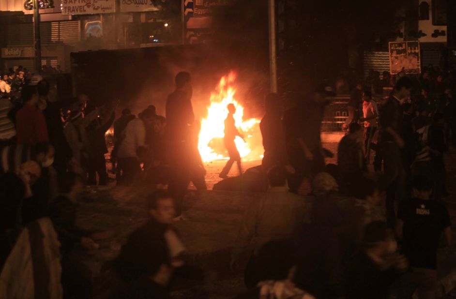 A burning truck illuminates a crowd of protesters in Tahrir Square on Saturday.