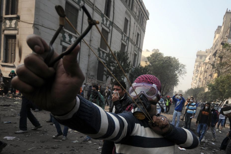A young Egyptian fires a slingshot during clashes with police Tuesday in Tahrir Square.
