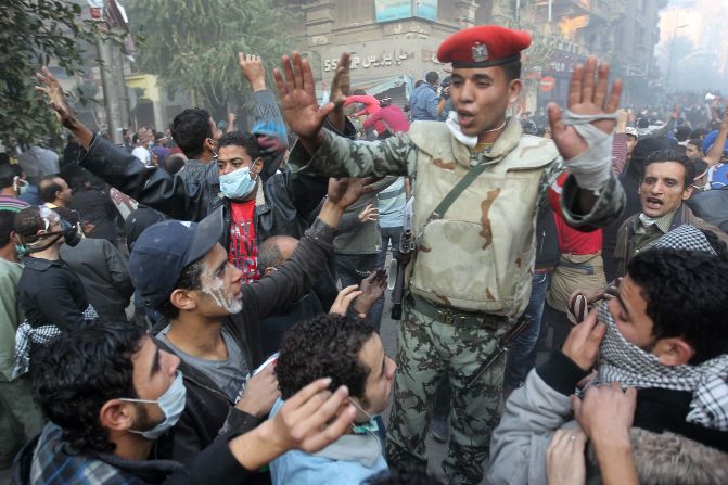 An Egyptian soldier attempts to control a crowd of protesters Tuesday in Tahrir Square.