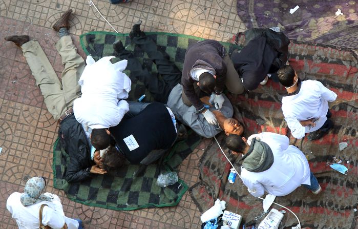 Doctors at a makeshift hospital in Tahrir Square tend to protesters hit by tear gas on Wednesday.