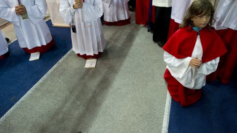 Altar servers kneel during the Mass celebrated by Pope Benedict XVI at the Olympic stadium in Berlin on September 22.