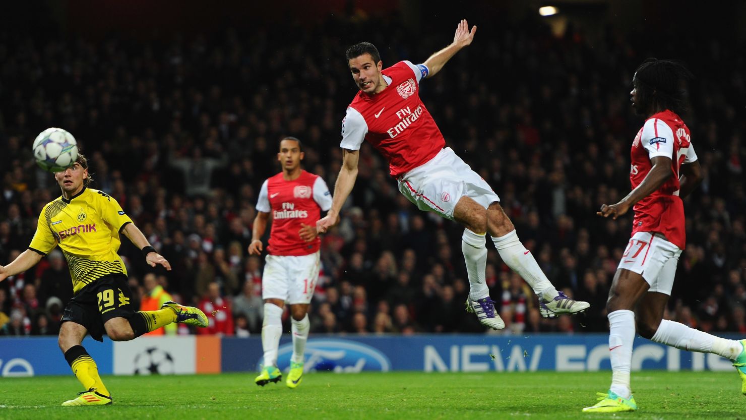 Robin van Persie flies through the air to head home his opening goal as Arsenal secured their place in the last 16.
